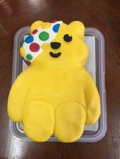 A yellow bear shaped cake

AI-generated content may be incorrect.